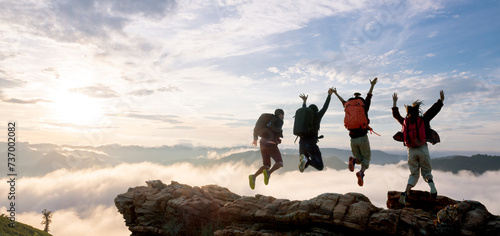 Group of happy hiker jumping on the hill