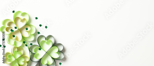 Paper four leaf clover with confetti on white background. St Patrick's Day banner design.