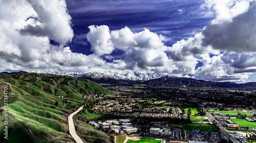 Aerial view of Yucaipa, California after a winter storm with snow covered San Bernardino Mountains, Crafton Hills, Chapman Heights and Yucaipa Valley Golf Course