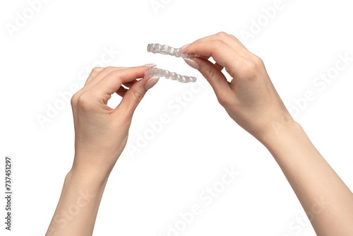Transparent mouth guard in a woman's hand isolated on white background.