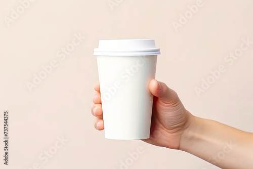 Hand holding white paper cup in the style of minima