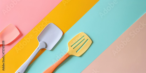 Assorted Different Silicone Baking Spatulas on colored Background. Vibrant multicolored silicone baking spatulas, background for confectioner's store.