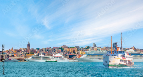 Cruise ship and ferry (steamboat) traffic in the Bosphorus - Sea voyage with old ferry (steamboat) on the Bosporus - Coastal cityscape with modern buildings and Galata Tower - Istanbul, Turkey 
