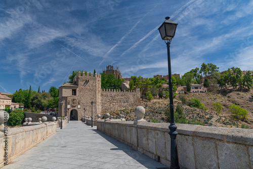 Toledo, Spain. Alcazar and Alcantara Bridge ( Puente de Alcantara), an arch bridge in Toledo, spanning the Tagus River