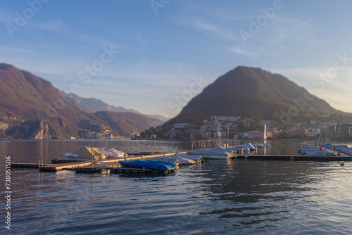 Tilt shift effect of mooring for pleasure boat in the Lugano Lake. San Salvatore Peak and Campione d'Italia town blurred in the background. Special effect photography concept