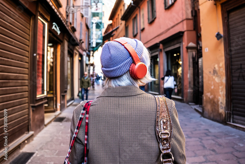 Gen z girl wearing chic trendy clothes - stylish gen z trendsetter in checkered coat and red headphones, embodying eclectic fashion with confidence and attitude - Vibrant urban chic