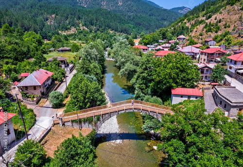 Aerial view of the old stone bridge over Aoos river at Vovoussa village, Zagori region, Ioannina, Epirus, Greece.