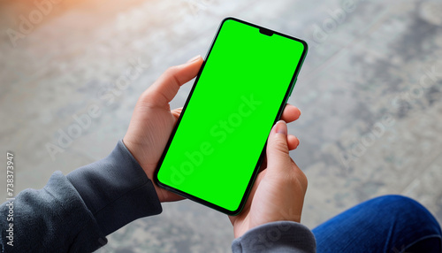Mockup image of a business people holding smart mobile phone with blank green screen