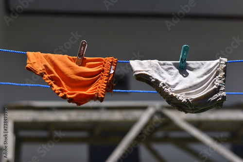 Woman panties on rope clothespin on blur background