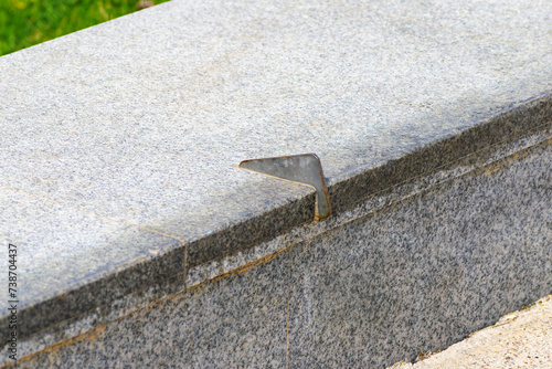 Anti-skateboarding devices on a stone fence. Anti roller spike