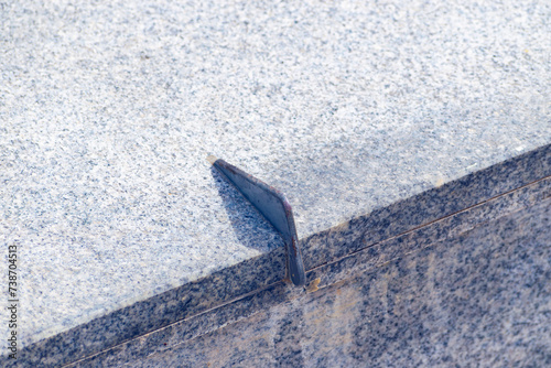 Anti-skateboarding devices on a stone fence. Anti roller spike