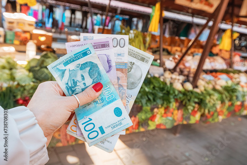 economic pulse of Serbia as shoppers peruse local markets, exchanging dinars for fresh produce and vital groceries, embodying the resilience of the nation's economy.