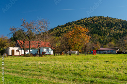 farma u podnóża góry w kolorowym jesiennym krajobrazie