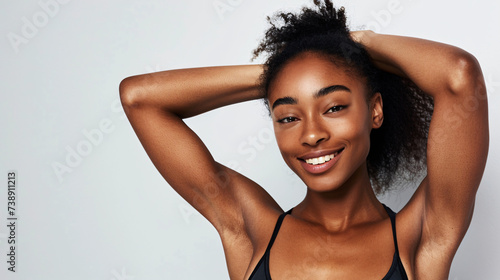 young beautiful sport influencer women showing armpit with smooth clean skin on solid background