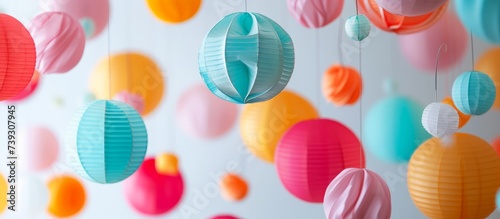 Vibrant array of colorful paper lanterns hanging elegantly from a delicate string