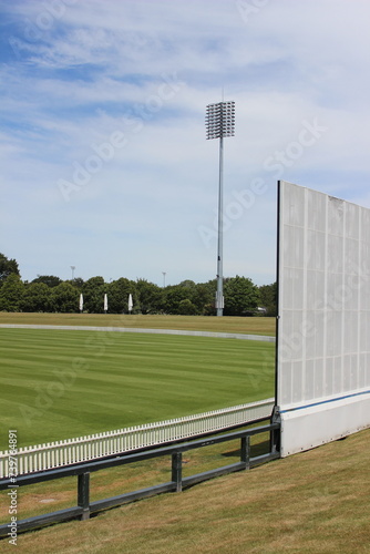 A light tower and sight screen associated with a cricket ground in Christchurch, New Zealand. 