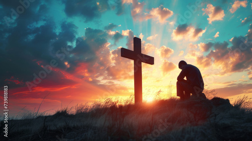 Christian man praying in front of the cross