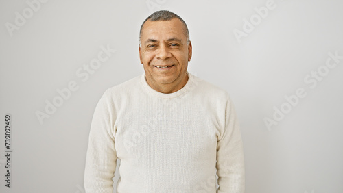 A middle-aged hispanic man in casual attire smiles warmly against an isolated white background.