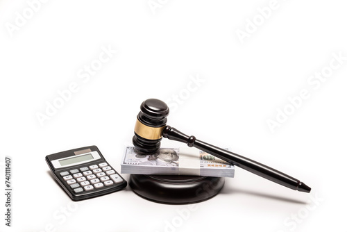 An isolated image of a judge's gavel on a stack of cash with a calculator, signifying legal fines or bail.