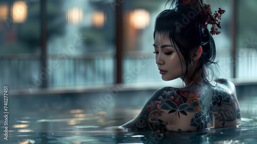 Japanese geisha sits in a Japanese onsen, showing her full body intricate Japanese style tattoos. Hair up in Geisha style bun