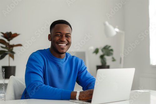 Happy Black Professional Man Working at Desk in front of Laptop