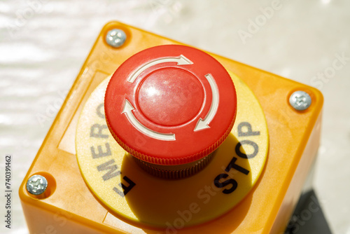A red Emergency STOP button used for safety on industrial equipment, machine machinery electrical system emergency shutdown mechanism, nuclear power plant, factory, workers safety security concept