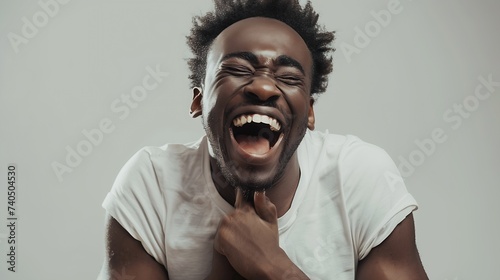 Positive and joyful Afro American male with fine crop of hair bursting into laughing holding his hands on stomach cant stopping laughing after hearing funny anecdote Positive emotions : Generative AI