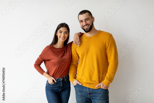 Portrait Of Happy Young Man And Woman Posing Over White Wall Background