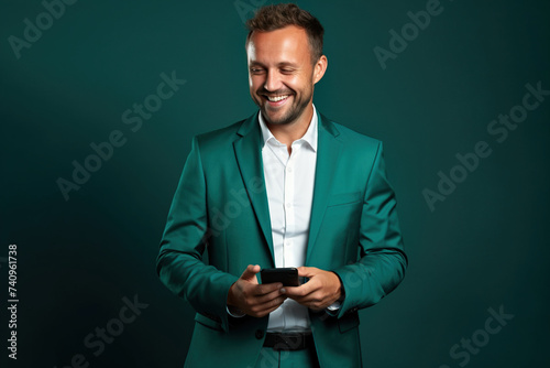 Man with phone on Forest Green studio background