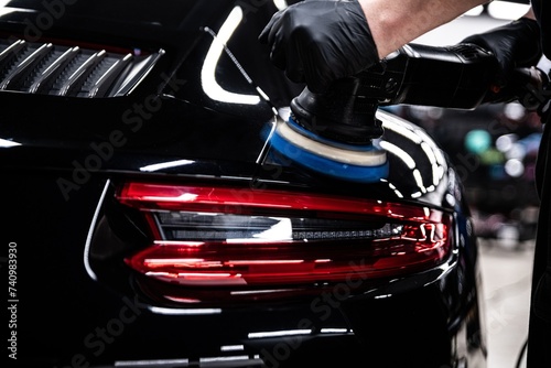 Precision auto detailing, high-gloss finish on luxury car