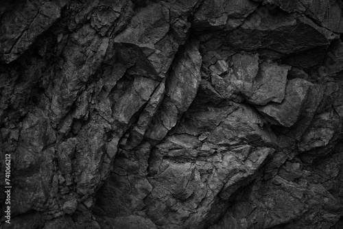 Black white dark gray rock stone basalt mountain granite volcanic texture background. Close-up. 3d. Cracked collapse, broken, crumbled.