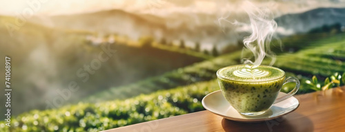 Aromatic matcha tea with a delicate foam art, overlooking tea fields. This warm cup is set before a vista of vibrant green rows of tea. Panorama with copy space.