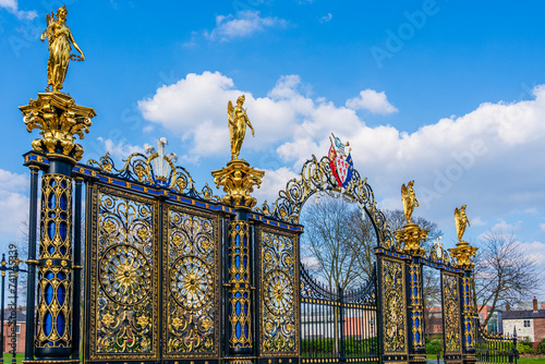 The Golden Gates, historical ornate Victorian gateway from 1862 located in front of the Town Hall in Warrington, Cheshire, England, UK; Text: "God gives growth"