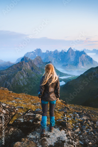 Woman solo traveler hiking in Norway exploring mountains of Lofoten islands tourist traveling outdoor alone healthy lifestyle summer vacations adventure extreme tour