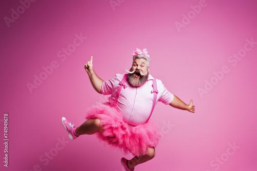 Bearded Man Pointing Upward in Pink Fairy costume