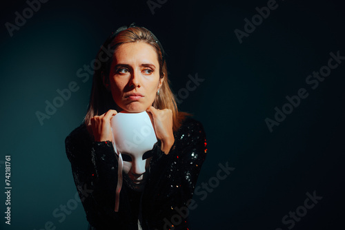 Sad Woman Holding a Theater Mask Feeling Depressed. Unhappy actress suffering from anxiety and negative thinking 