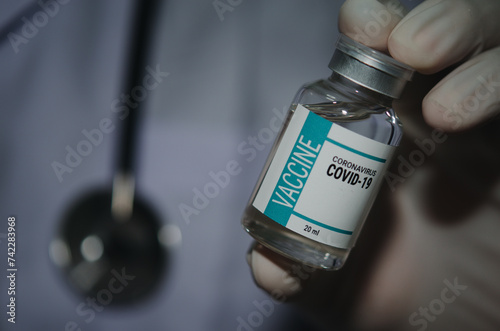 Male doctor holding a bottle of COVID-19 vaccine medicine Or the coronavirus vaccine