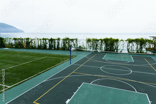 Outdoor Volleyball court with a net in the morning next to the sea.