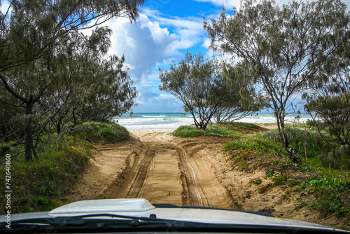 First person view of a driver travelling onboard a 4x4 pickup on a sand track in the rainforest of Fraser Island, Queensland, Australia