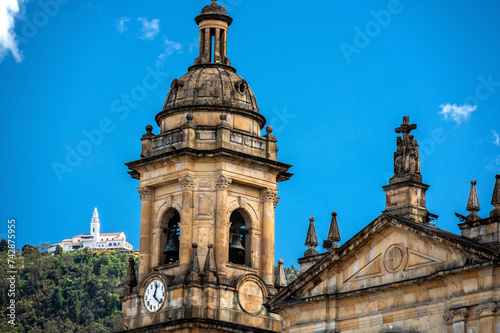 Closeup view of one of the towers of the cathedral in Bogota, Colombia with the iconic Monserrate in the background