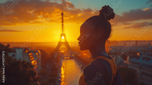 Portrait of a determined black female sprinter competing for gold medal near the Eiffel Tower