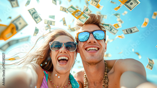 Exuberant young couple taking a selfie with money raining down, epitomizing wealth and carefree luxury.