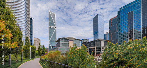 Panoramic view of a downtown skyscrapers with trees and a path in a park in the SOMA neighborhood in San Francisco, California