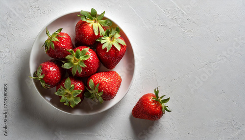 strawberries on a white plate , on a white background