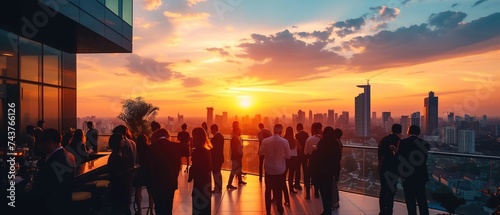 Rooftop business event against urban sunset view. Corporate gathering with city skyline view.