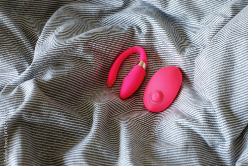 pink sex vibrator in bed. sex toys