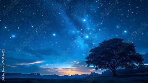 Blue dark night sky with many stars above field with tree trees. Milkyway cosmos background