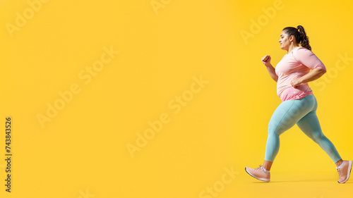 A graceful woman wearing a vibrant yellow shirt moves with fluidity, her feet adorned in elegant footwear, as she dances with joy and confidence