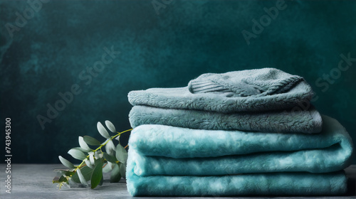 Bath towels in sage green color on dark background, home textile concept