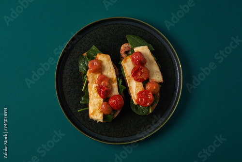 open sandwich with grilled tomatoes and grilled cheese. top view